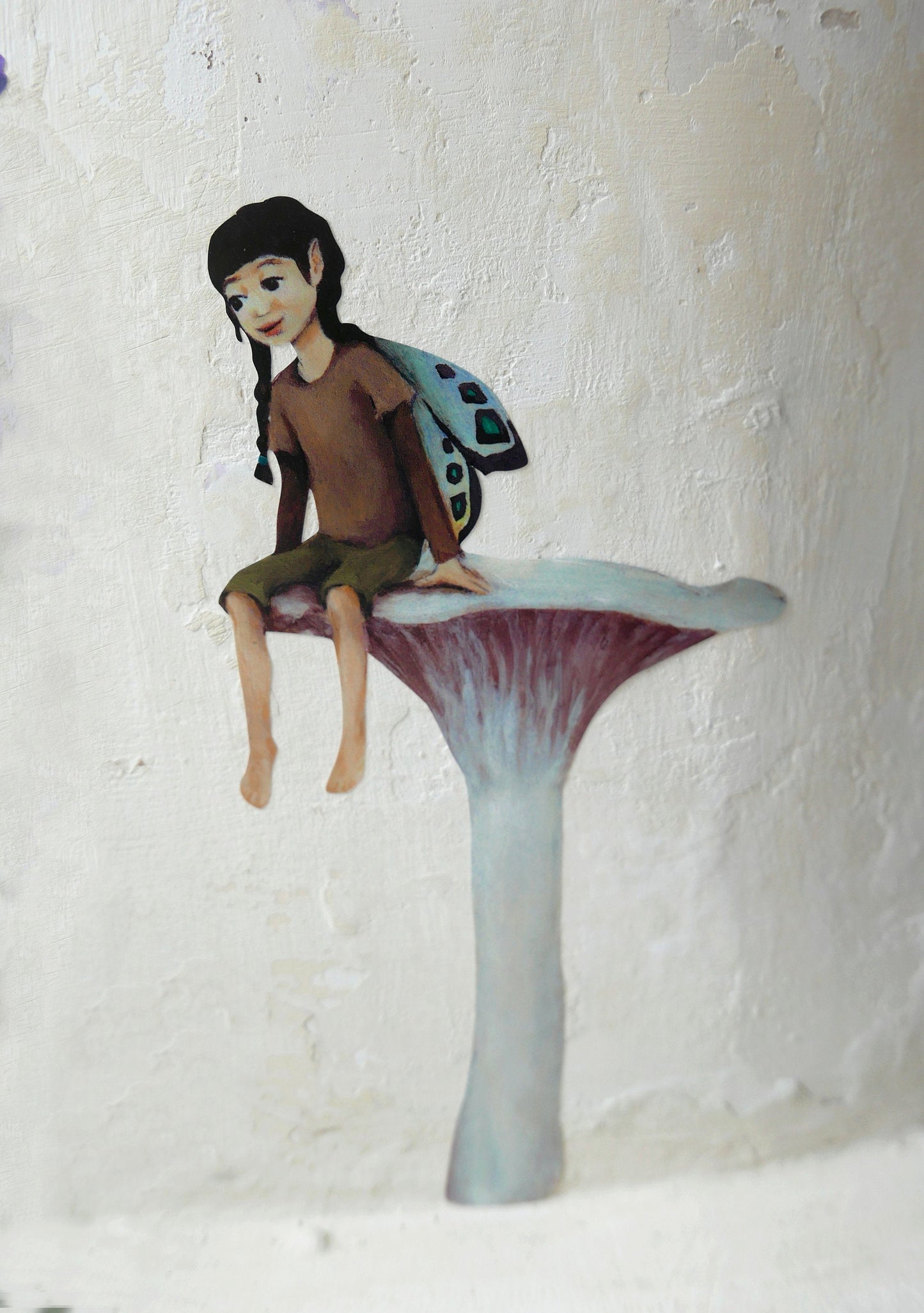 fairy resting on a mushroom