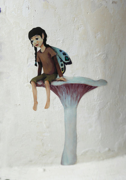 fairy resting on a mushroom