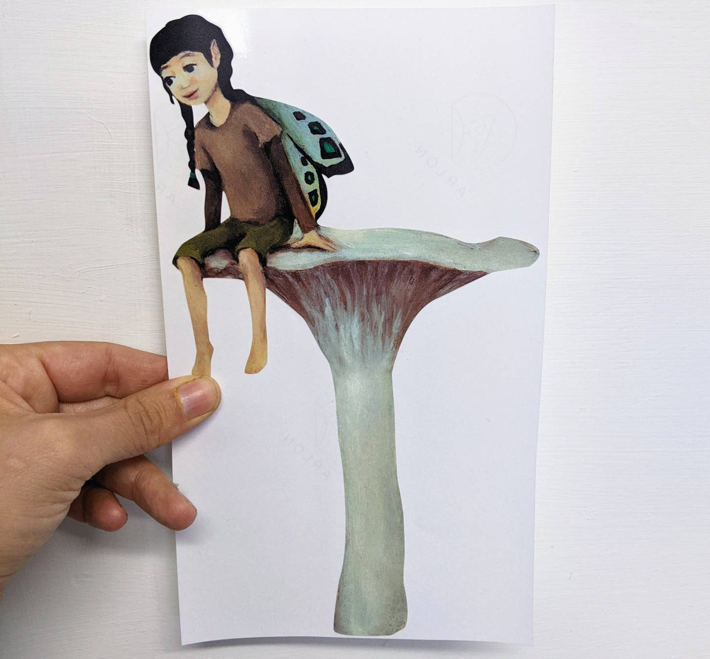 fairy resting on a mushroom