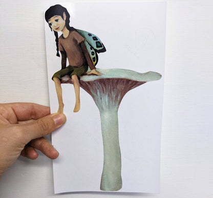 fairy resting on a mushroom