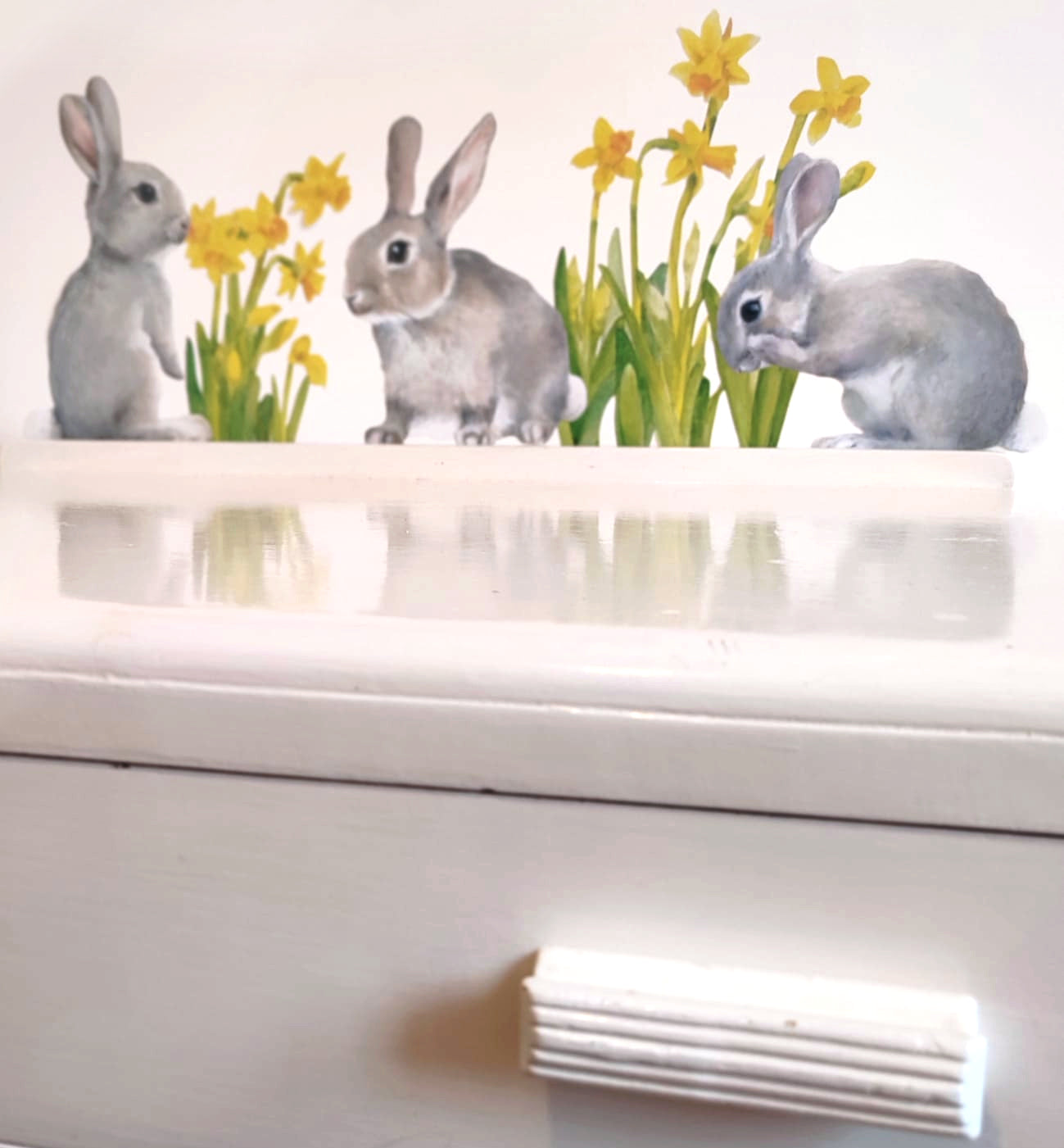 Decorative wall stickers of rabbits and flowers on a white surface