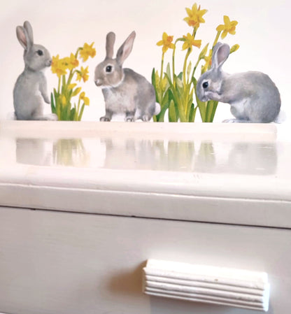 Decorative wall stickers of rabbits and flowers on a white surface