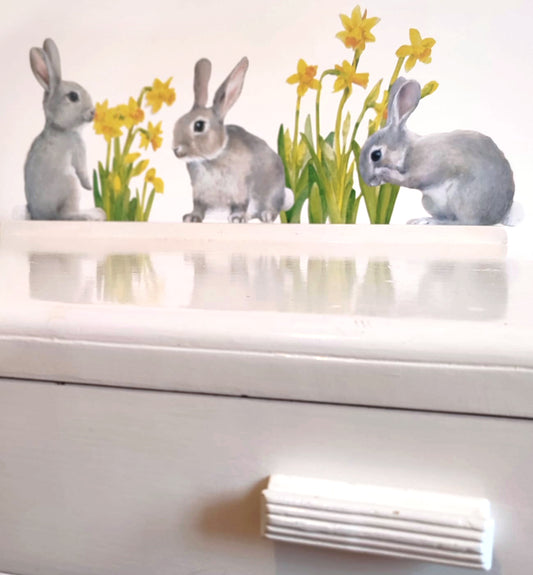 Decorative wall stickers of rabbits and flowers on a white surface