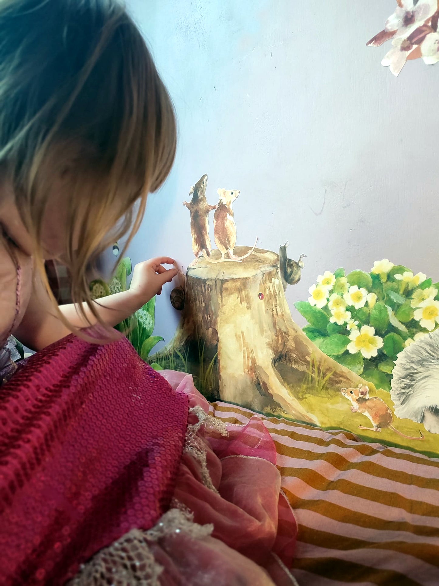 girl rearranging fabric decals by the mice of slad road
