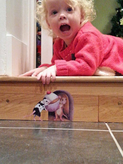 girl looking excited to find a mouse hole in the step featuring 2 mice carrying a cupcake into a hole