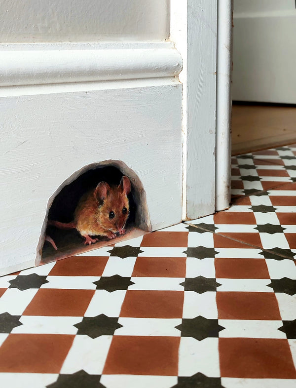 decal picturing a brown mouse in a hole looking out over a brown black and white tiled floor